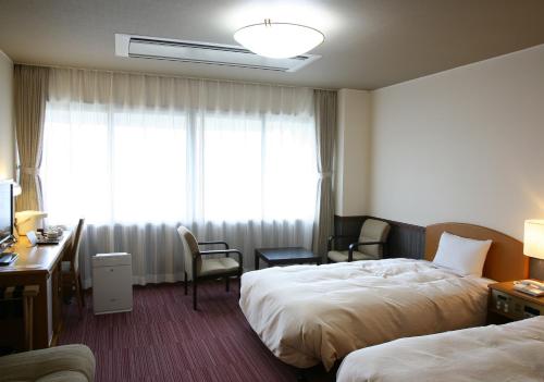 Een bed of bedden in een kamer bij Miyamaso
