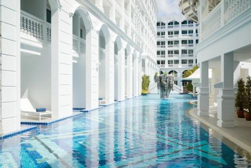 a hallway of a building with a pool at Mövenpick Myth Hotel Patong Phuket in Patong Beach