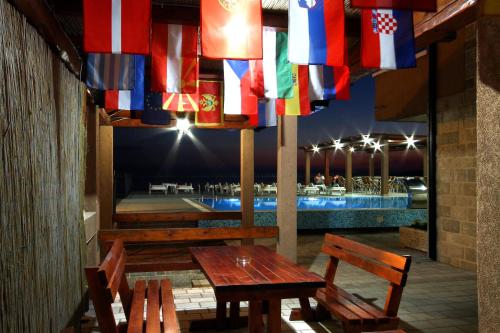 a table and chairs on a patio with flags at Apartments Đurašević in Sveti Stefan