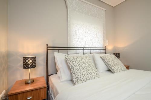 a bedroom with a bed and a lamp on a table at Casa D'Irene Apartments in Athens in Athens