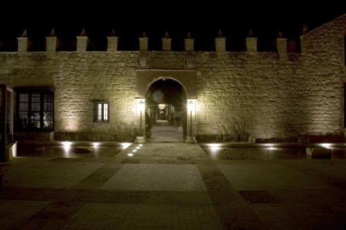 an entrance to a stone building at night at Hotel Palacio de Mengibar in Mengibar