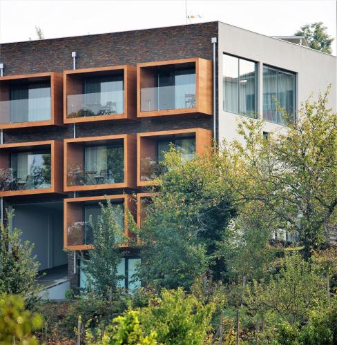 an apartment building with trees in front of it at Casa de Campo Memórias da Comarca in Arganil