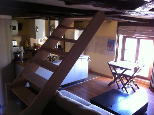 a ladder in a living room with a kitchen at CHAPELLE ST NICOLAS in Roanne
