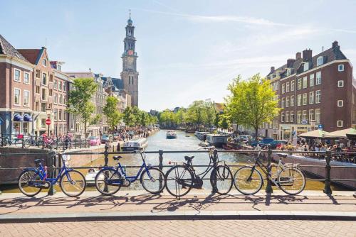 a group of bikes parked on a bridge near a canal at St Christophers Inn at The Winston in Amsterdam