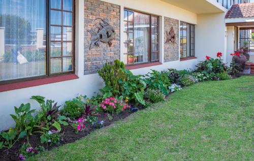 a row of flowers on the side of a house at Crowned Crane in Gonubie