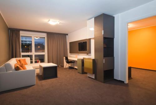 a hotel room with a bed and a desk at Hotel City Maribor in Maribor