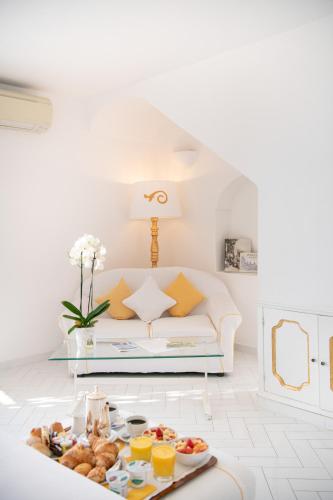 a living room with a couch and a tray of food at Villa Yiara in Positano