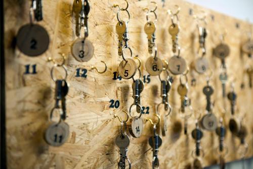 a bunch of keys hanging on a wall at Schwendi Lodge in Unterwasser