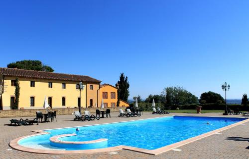 a swimming pool in front of a building at Il Borgo di Montereggi in Limite