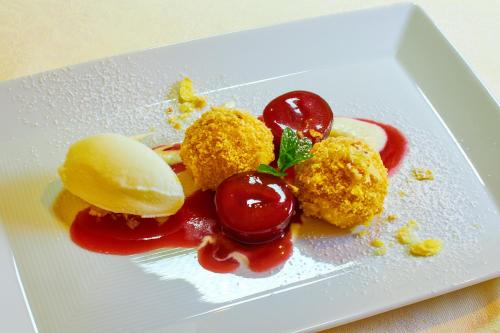 a white plate with some food on it at Hotel Brötz in Rasùn di Sotto