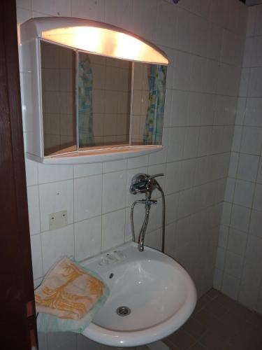 a bathroom with a white sink and a mirror at Hotel Max Šimek in Ostrava