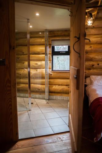 a room with a bed and a window at Coed y Marchog Woodland Retreat in Hereford