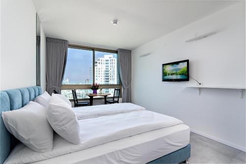 a hotel room with a bed and a window at Netanya SeaView ApartHotel in Netanya