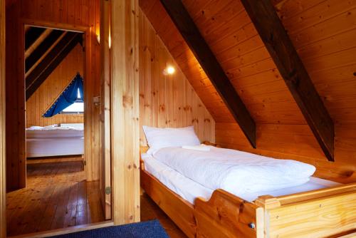 a bedroom with a bed in a wooden cabin at Birkihof Lodge in Laugarvatn