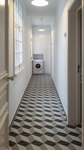 a laundry room with a black and white floor at CC Guest House - "Ao Mercado" in Ponta Delgada