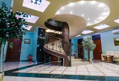 a spiral staircase in a building with a lobby at Donskaya Riviera Hotel in Rostov on Don