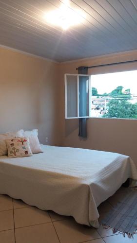 um quarto com uma cama grande e uma janela em Apartamento inteiro 2 quartos Wi-Fi em Montes Claros