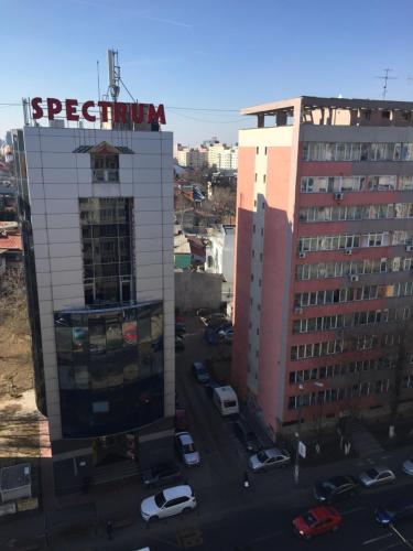 a tall building with a sign on the side of it at Roby apartament in Bucharest