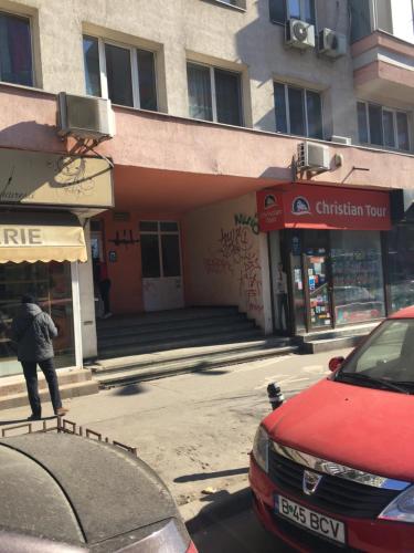 a person standing in front of a building at Roby apartament in Bucharest