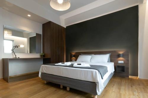 a bedroom with a large bed with a black wall at TONI'S Cute 2BD Apartment in Koukaki! in Athens