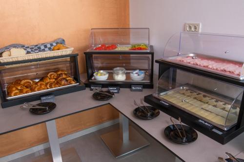 a display case with different types of pastries and other foods at Apartments Oliva in Premantura