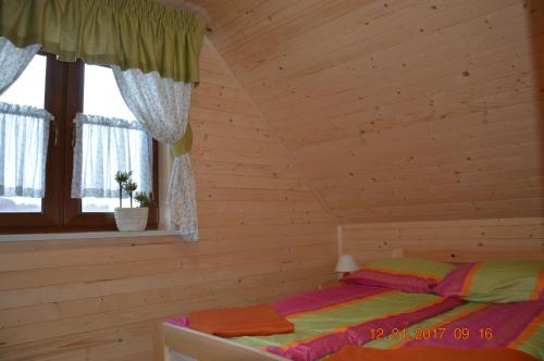 A bed or beds in a room at Ośrodek Wypoczynkowy Mewa