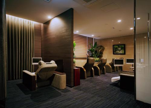 a waiting room with a row of chairs and desks at SHIROYAMA HOTEL kagoshima in Kagoshima