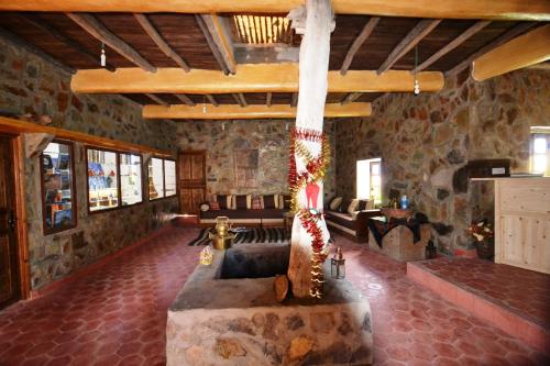a living room with a cross in the middle of a room at Tizourgane Kasbah in Tiguissas