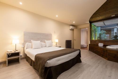 Een bed of bedden in een kamer bij Apartamentos DV