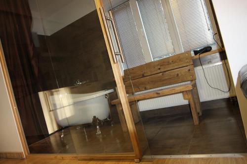 a room with a wooden bench and a window at Champêtre Park View Apartments in Rīga