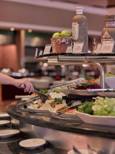 a buffet line with plates of food on display at Bourbon Resort Atibaia in Atibaia