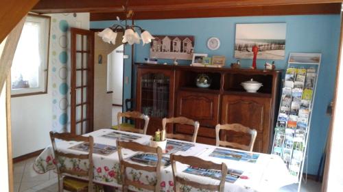 a dining room with a table and chairs in a room at la picarde in Tours-en-Vimeu