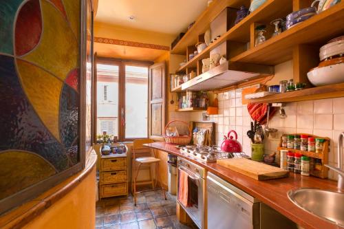a kitchen with a sink and a stove top oven at Charming Colosseum apartment in Rome