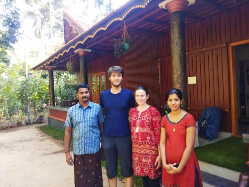 a group of people standing in front of a house at Munroe Meadows in Munroe Island