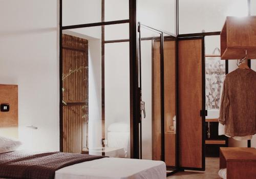 a bedroom with a bed and a glass door at Casa Anna in Ilbono