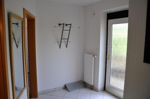 a bathroom with a ladder on the wall next to a door at Ferienwohnung Am Försterteich in Hagenburg