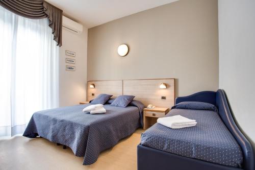Postel nebo postele na pokoji v ubytování Hotel Villa dei Gerani