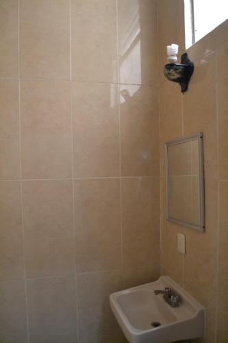 a bathroom with a sink and a mirror at Hotel Maya in Guadalajara