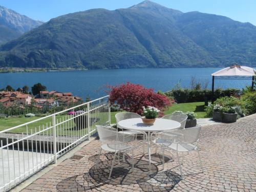 a table and chairs on a patio with a view of a lake at Ficano's Dream in San Siro