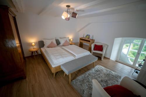1 dormitorio con cama, mesa y ventana en Schlosshotel Kirchberg, en Kirchberg an der Jagst