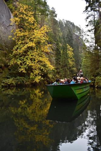 a group of people in a green boat on a river at Pension Růžák in Růžová