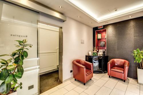 a lobby with two chairs and a table at Trevi 41 Hotel in Rome