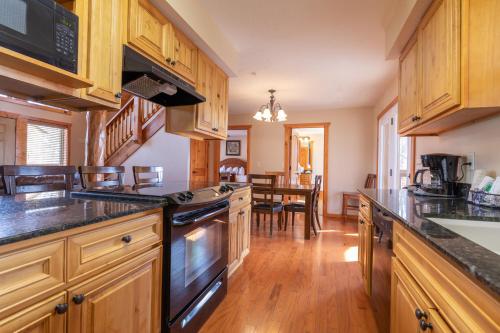 a kitchen with wooden cabinets and a dining room at The Lodges at Table Rock in Branson