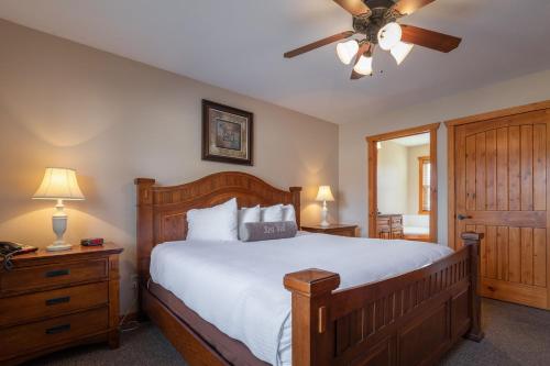 a bedroom with a bed and a ceiling fan at The Lodges at Table Rock in Branson