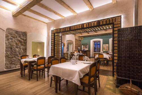 Castle Hotel Daniel في Baraolt: مطعم فيه طاولات وكراسي في الغرفة