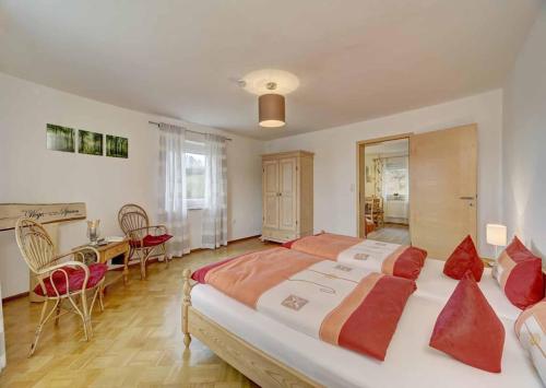 a large bedroom with a large bed and a table at Ferienwohnung Lankl im Bayerischen Wald in Röhrnbach