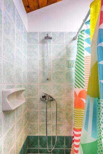 a bathroom with a shower with a colorful shower curtain at Zakynthos Seascape in Lithakia