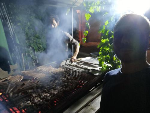a man is cooking food on a grill at Masseria Fachechi in Nardò