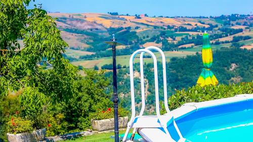a swimming pool with a light next to a pool at L'Angolo Di Verlano in Canossa