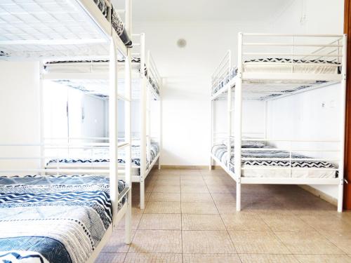 a room with four bunk beds and a tiled floor at The 17 Party Hostel in Lagos